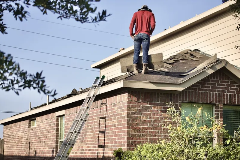 Professional roofer working on a residential roof in Heather Hills